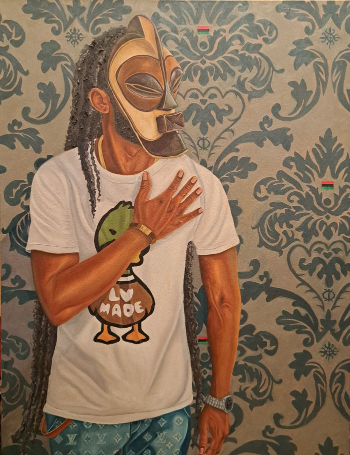 portrait of a man of color in modern clothing wearing a traditional African mask standing in front of blue and white decorative wallpaper; hidden in the pattern are African flags; his hand lay across his heart, as if standing for the pledge of allegiance