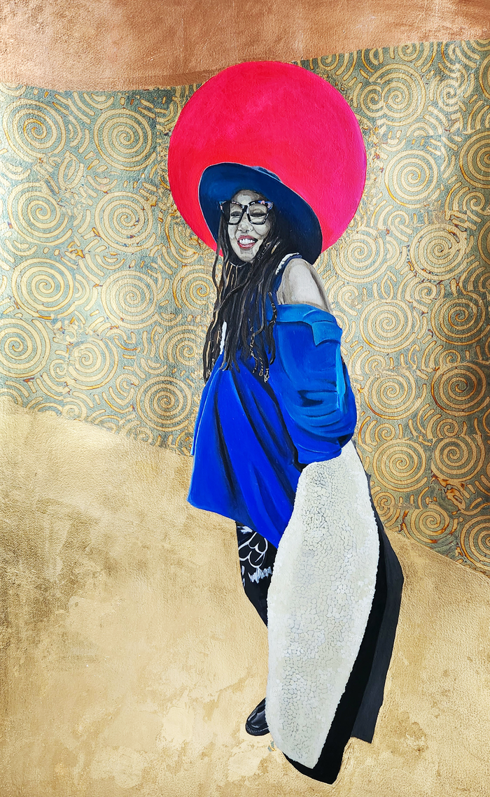 portrait of a black woman smiling; she has on a baggy blue off the shoulder top, a matching blue hat and has long dreadlocks; behind her is a red halo; the background is minimal with a circular patter covered in metal leaf