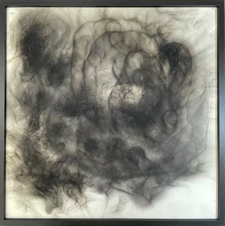 Abstract black and white artwork with swirling patterns on a textured surface.