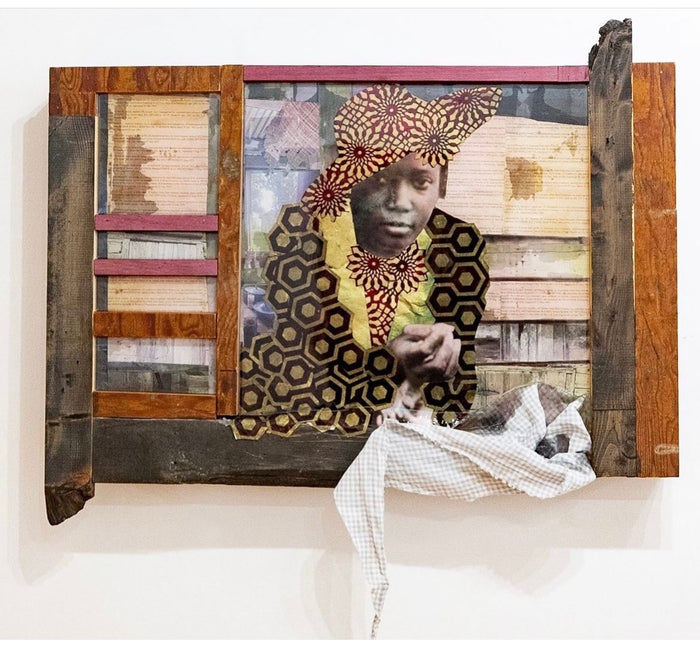 mixed media photographic collage featuring a black woman facing the viewer from inside a wooden assemblage; the background features layers of written text, and her clothing is shaped with patterned papers
