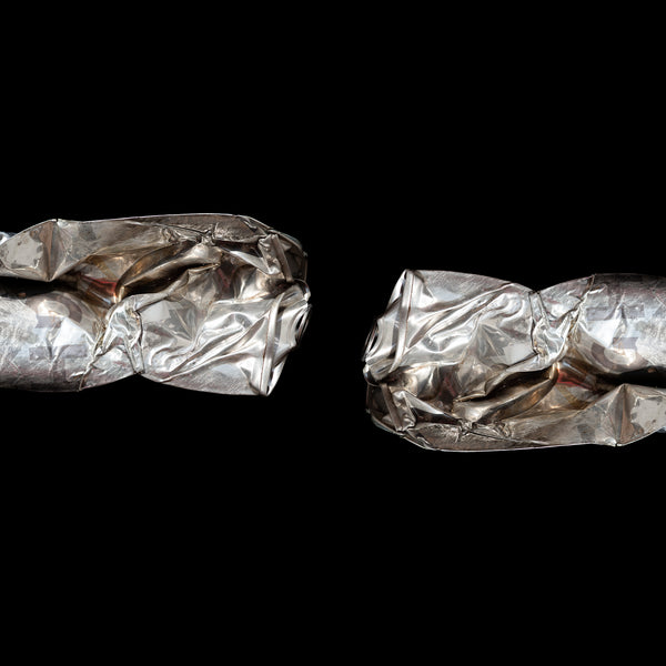 Photographic print of two crushed silver cans