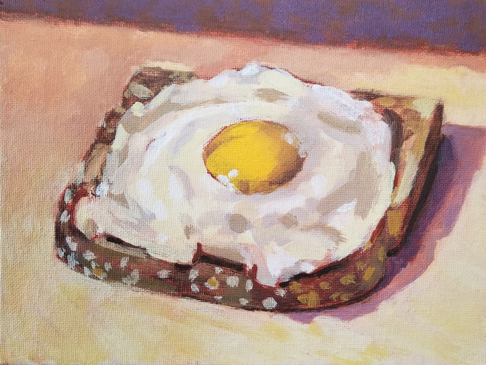 a fried egg on a slice of toast
