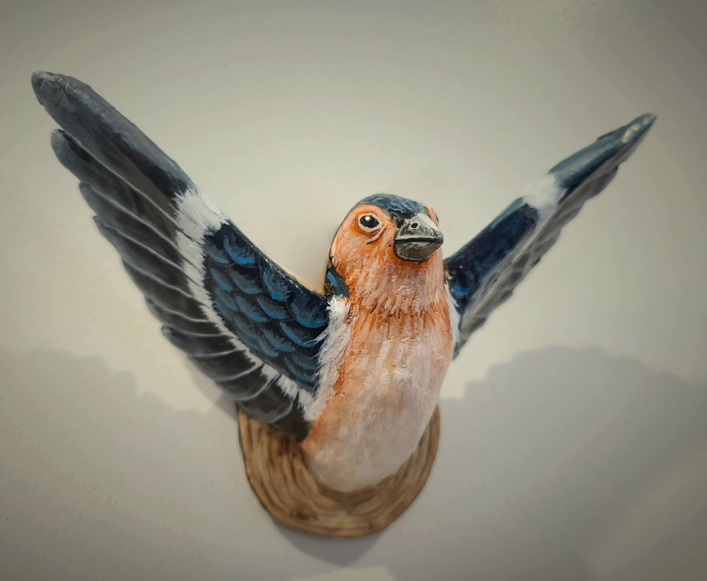 paper mache sculpture of a finch bird