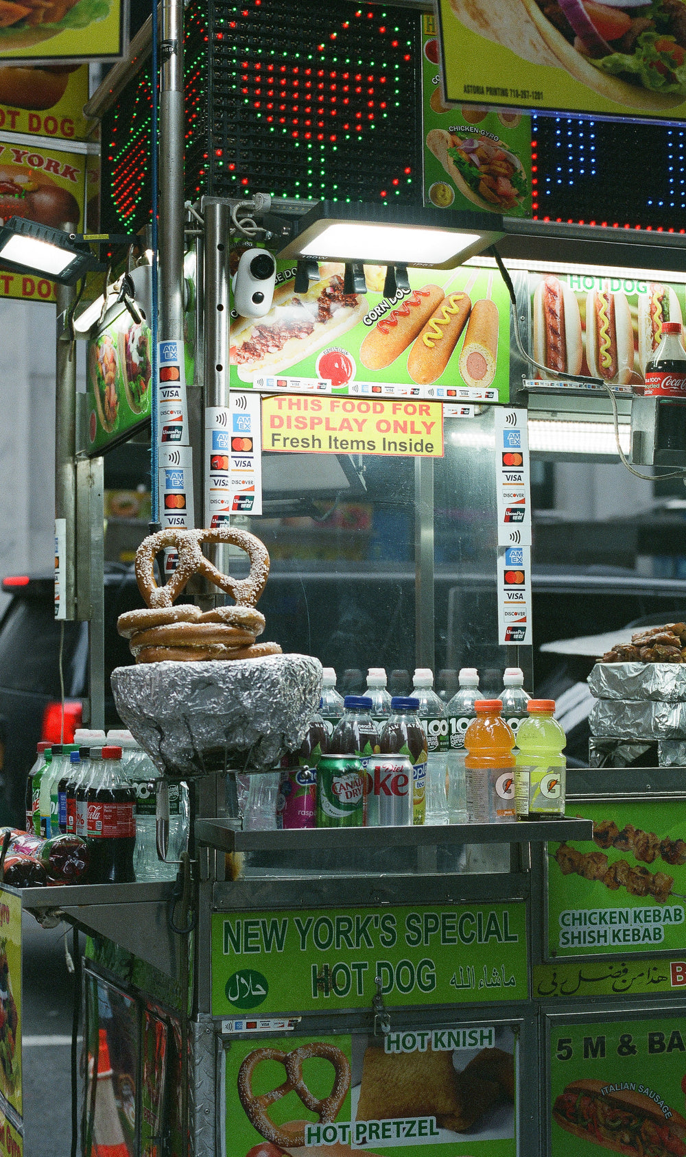photographic image of a pretzel stand at night