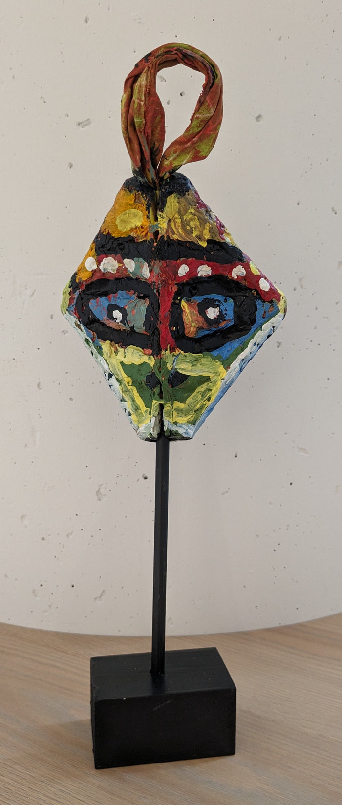 triangular face sculpture hand painted with African mask markings
