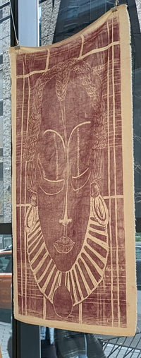 ink print of an African mask on raw canvas