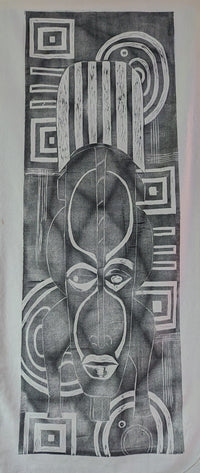 ink print of an African mask on raw canvas
