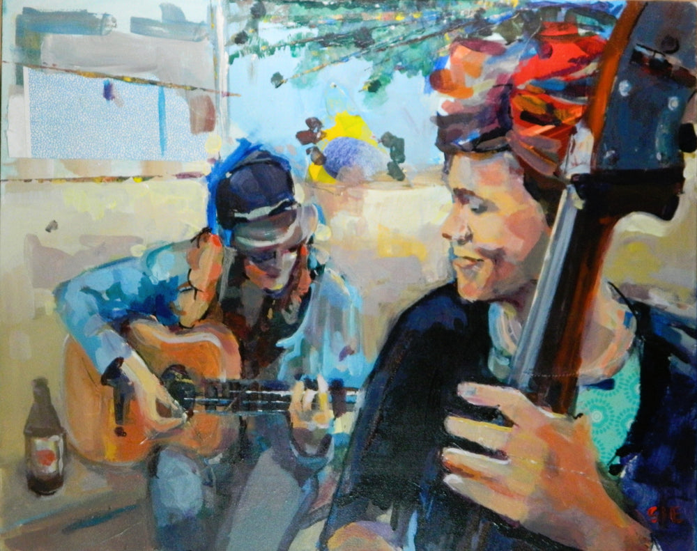 two women playing guitar outside