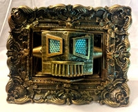 sculpture of a robot head inside a decorative frame