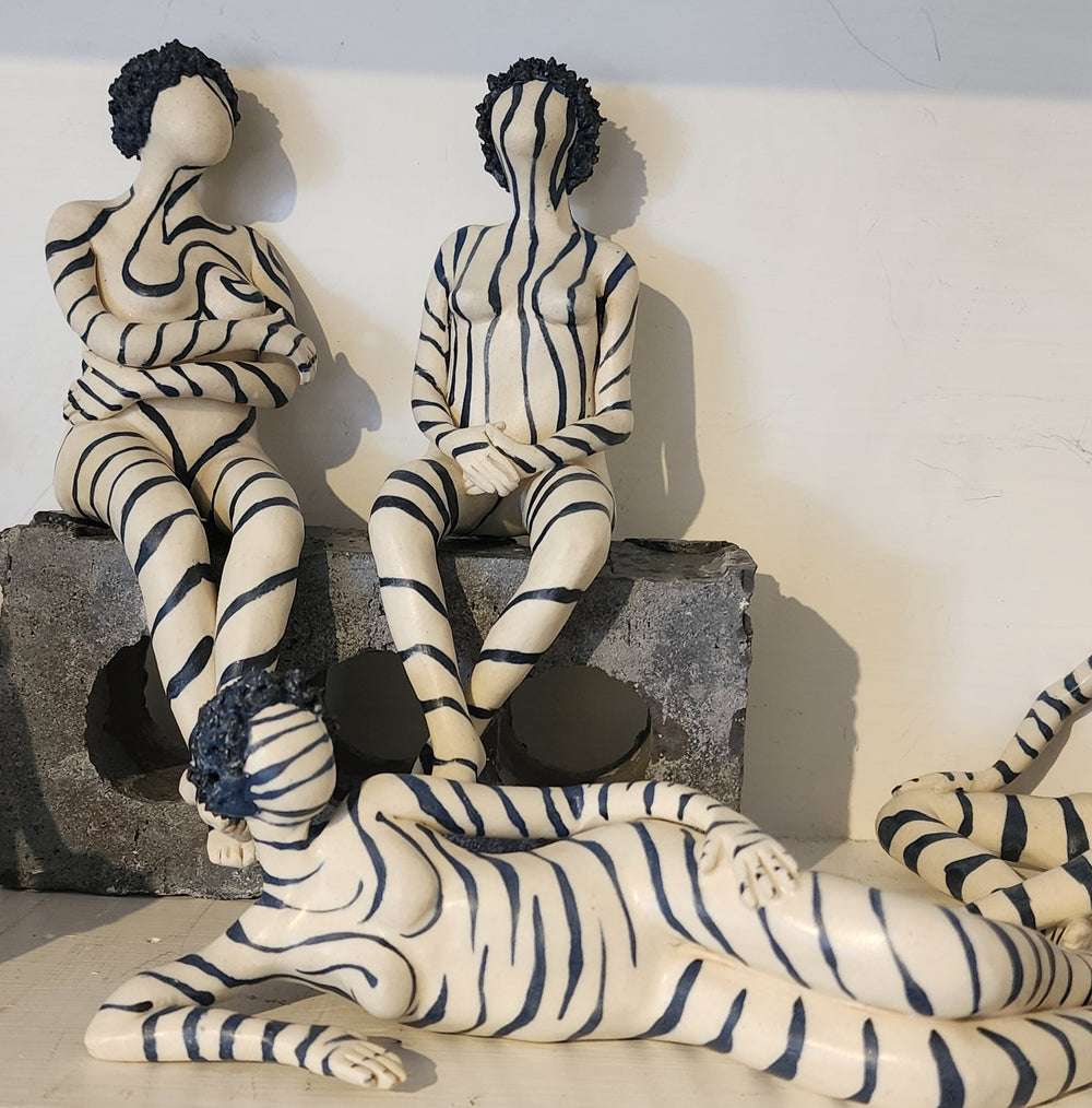 ceramic figures painted with a zebra stripe pattern