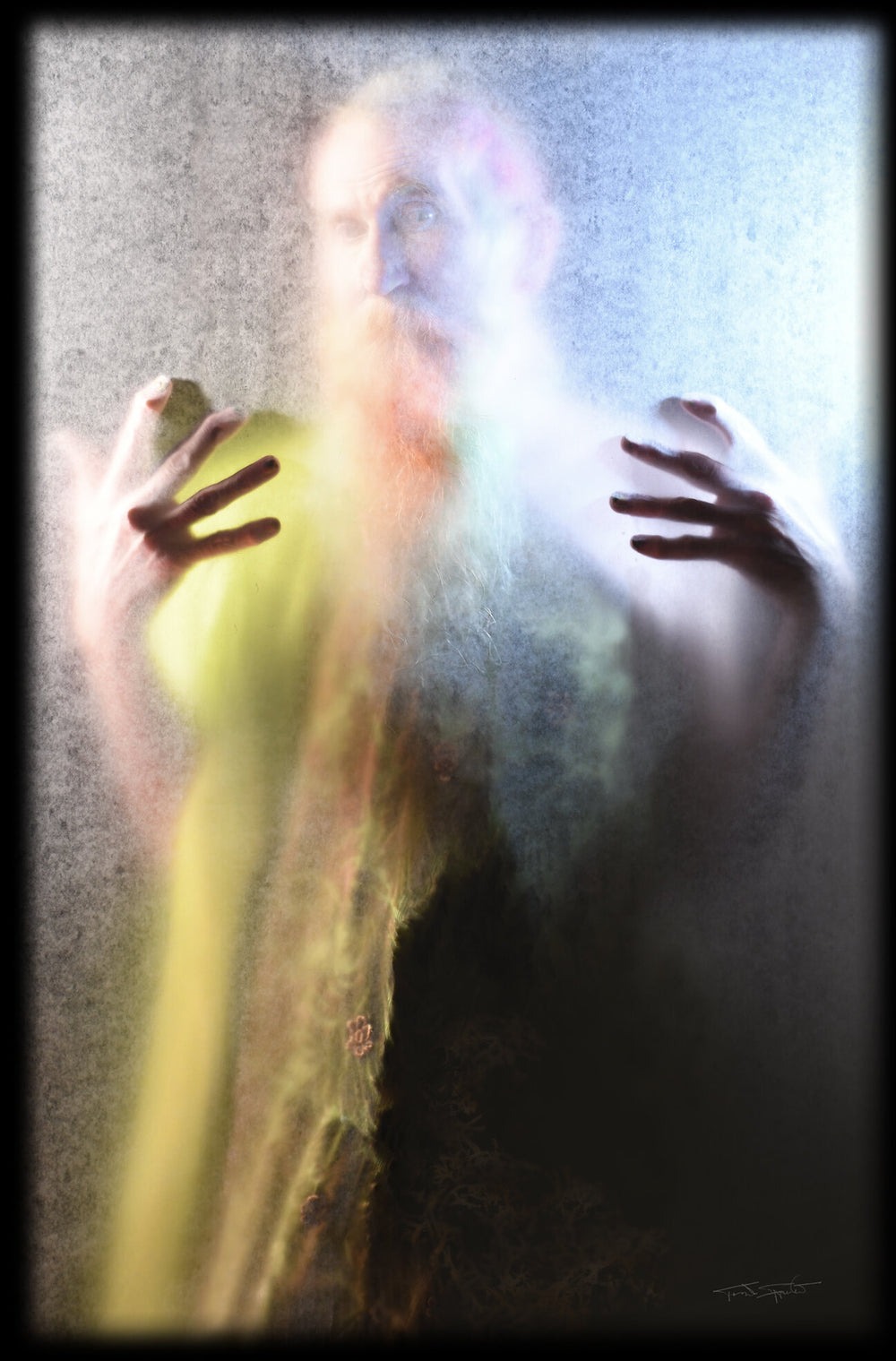 illuminated photograph of a bearded man with hands reaching out to the viewer