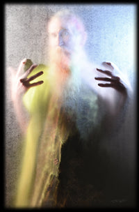 illuminated photograph of a bearded man with hands reaching out to the viewer